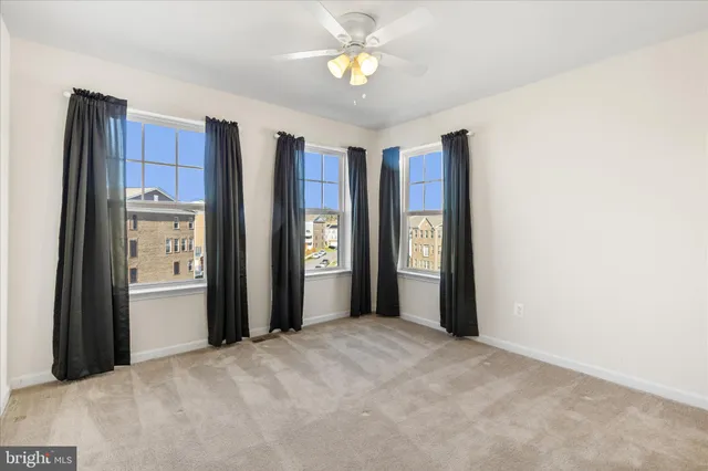 a view of a kitchen with wooden cabinet and a refrigerator