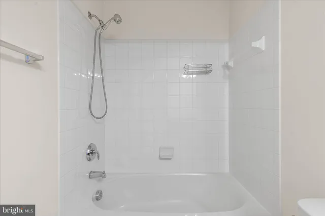 a bathroom with a bath tub with a shower