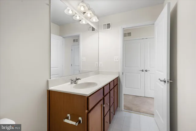 a bathroom with a sink a mirror and a shower
