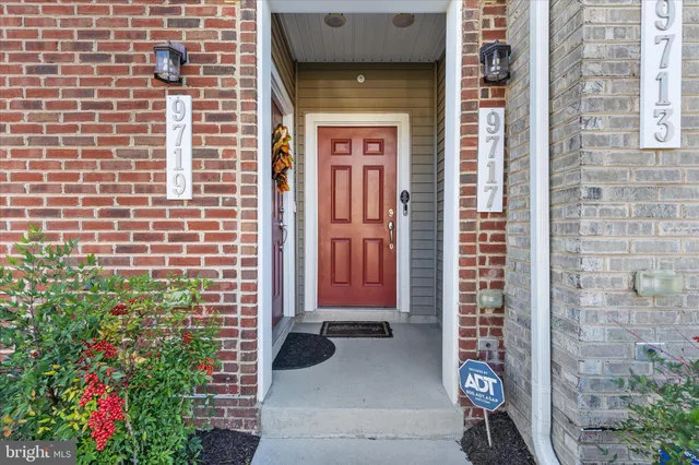 a front view of a house with a potted plant