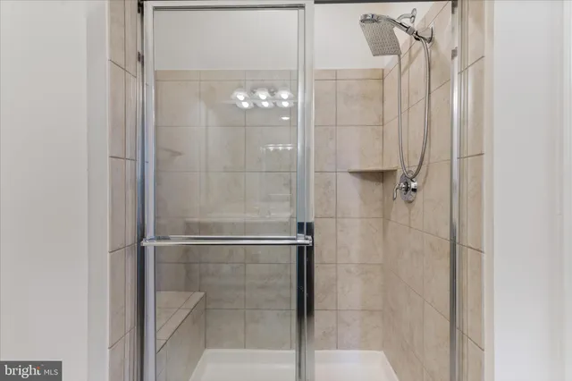 a bathroom with a glass shower door