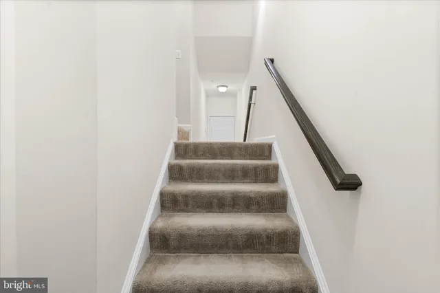 a view of staircase with white walls