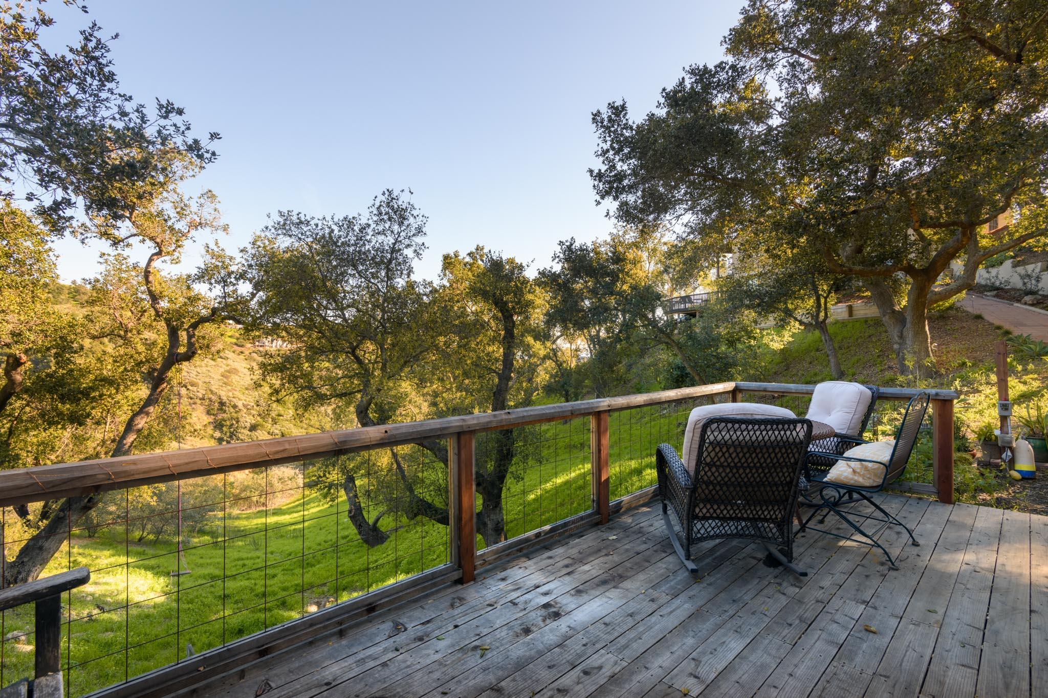 1250 Northridge Road Santa Barbara, CA 93105 - Photo 33 of 37 a roof deck with table and chairs and wooden floor