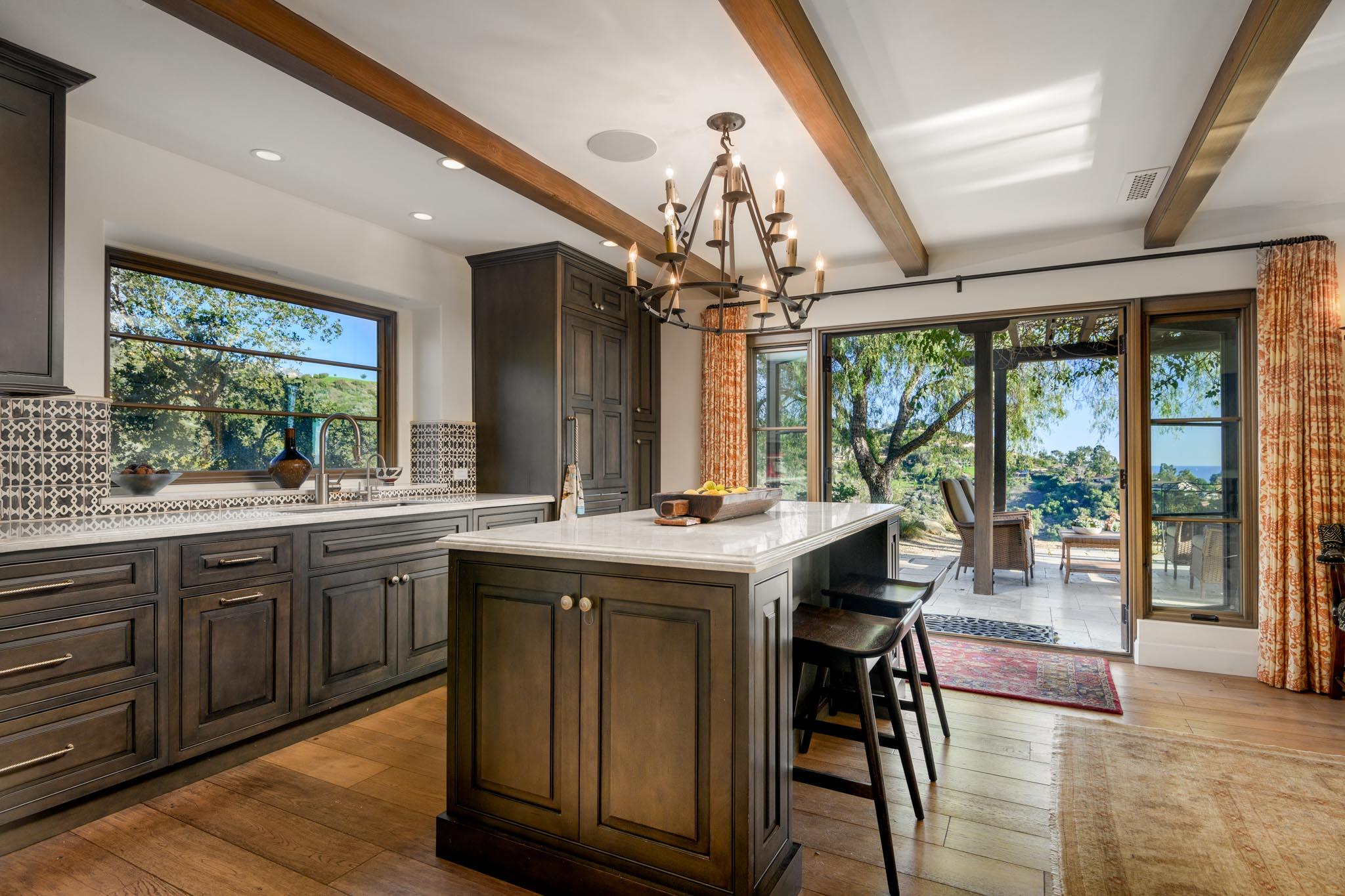1250 Northridge Road Santa Barbara, CA 93105 - Photo 9 of 37 a kitchen with stainless steel appliances granite countertop a stove a refrigerator a sink dishwasher a dining table and chairs with wooden floor