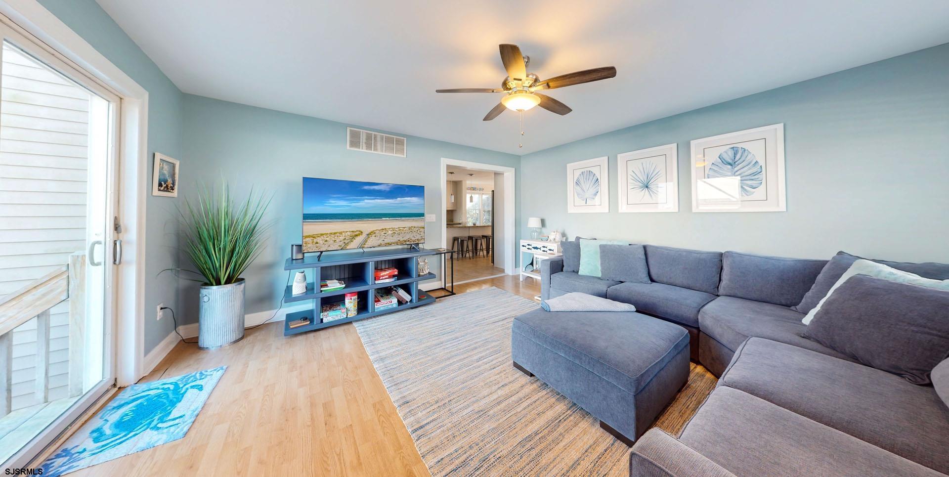39 Spruce Road Ocean City, NJ 08226 - Photo 20 of 51 a living room with furniture and a flat screen tv
