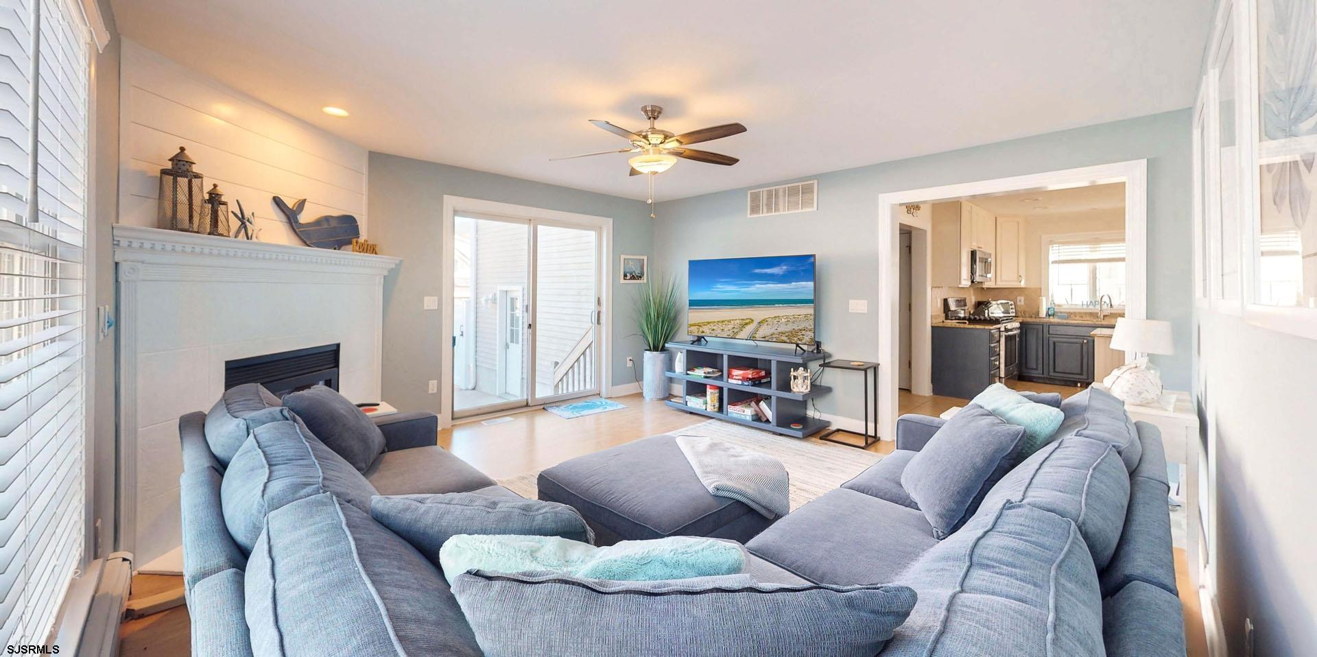 39 Spruce Road Ocean City, NJ 08226 - Photo 21 of 51 a living room with furniture a fireplace and a flat screen tv