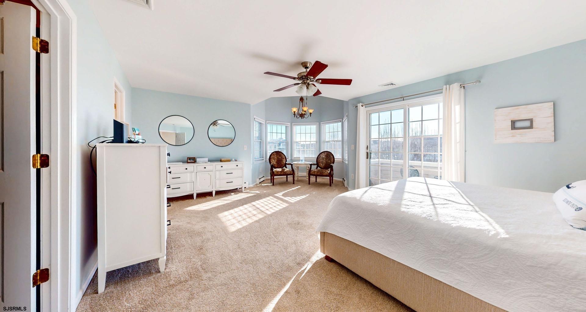 39 Spruce Road Ocean City, NJ 08226 - Photo 22 of 51 a spacious bedroom with a bed and a large window