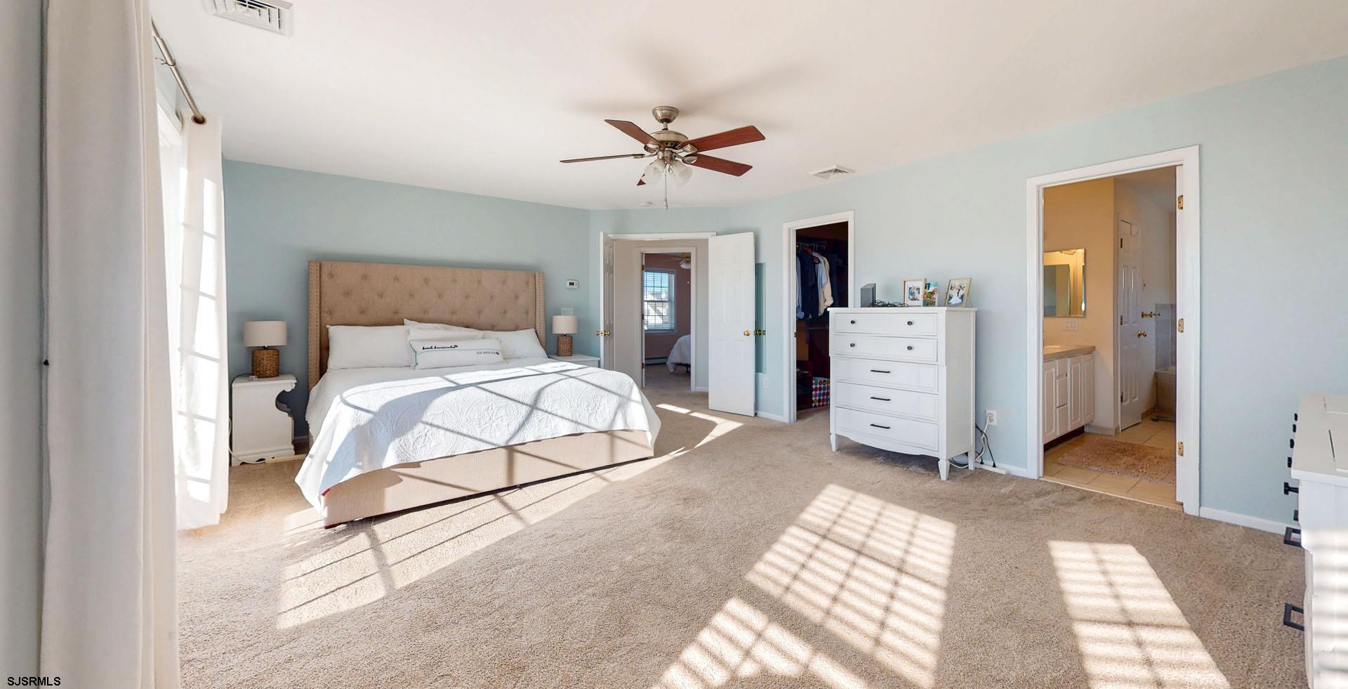 39 Spruce Road Ocean City, NJ 08226 - Photo 23 of 51 a bedroom with a bed and a chandelier