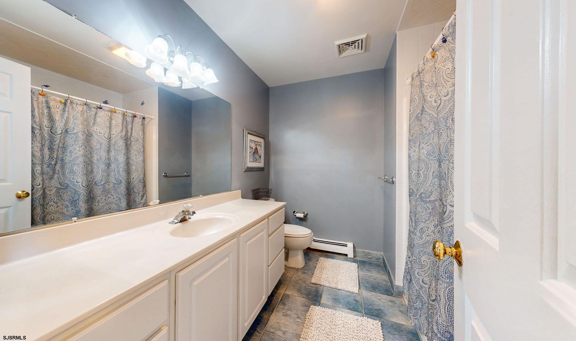 39 Spruce Road Ocean City, NJ 08226 - Photo 28 of 51 a bathroom with a sink a toilet and shower