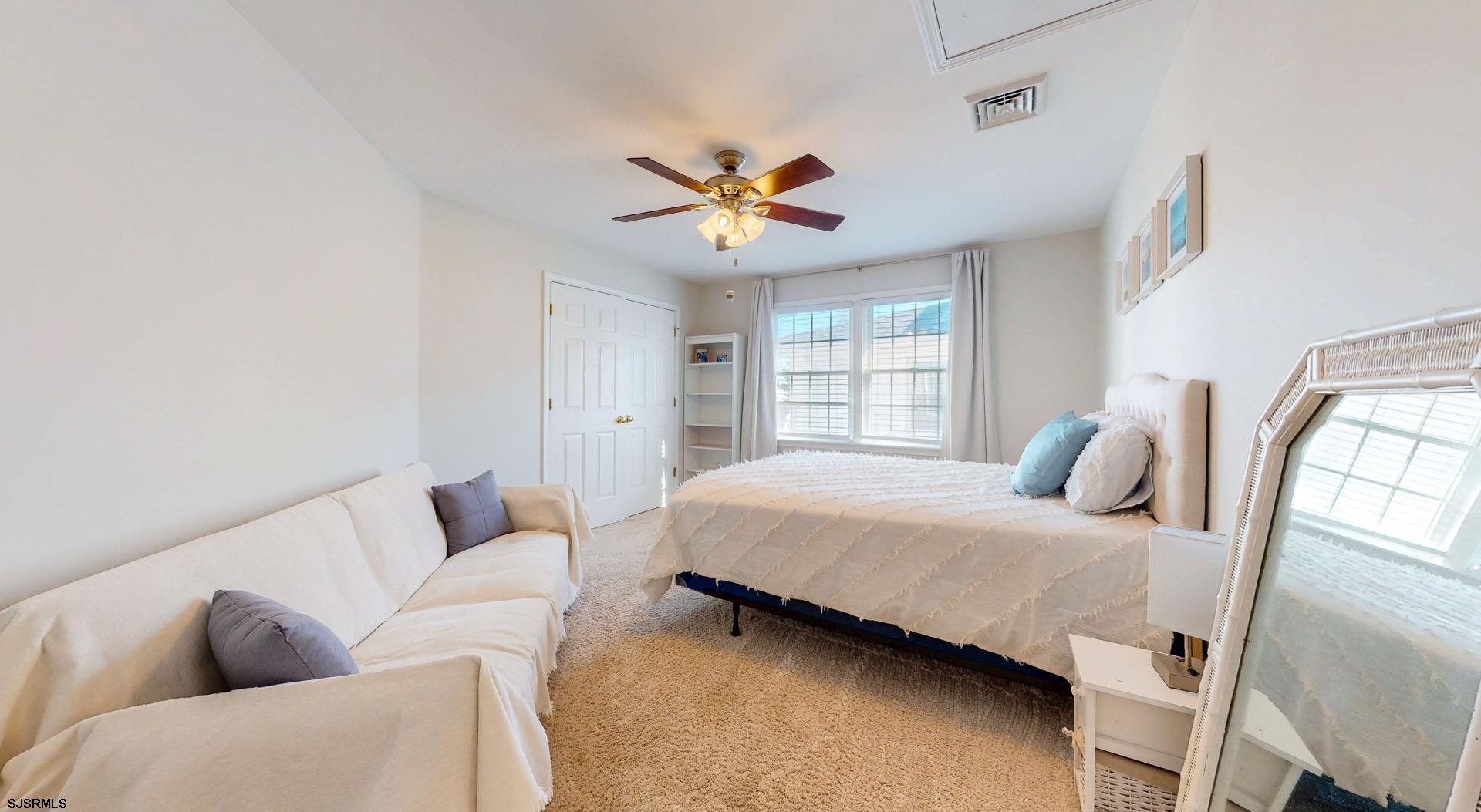 39 Spruce Road Ocean City, NJ 08226 - Photo 31 of 51 a bedroom with a bed couches and window