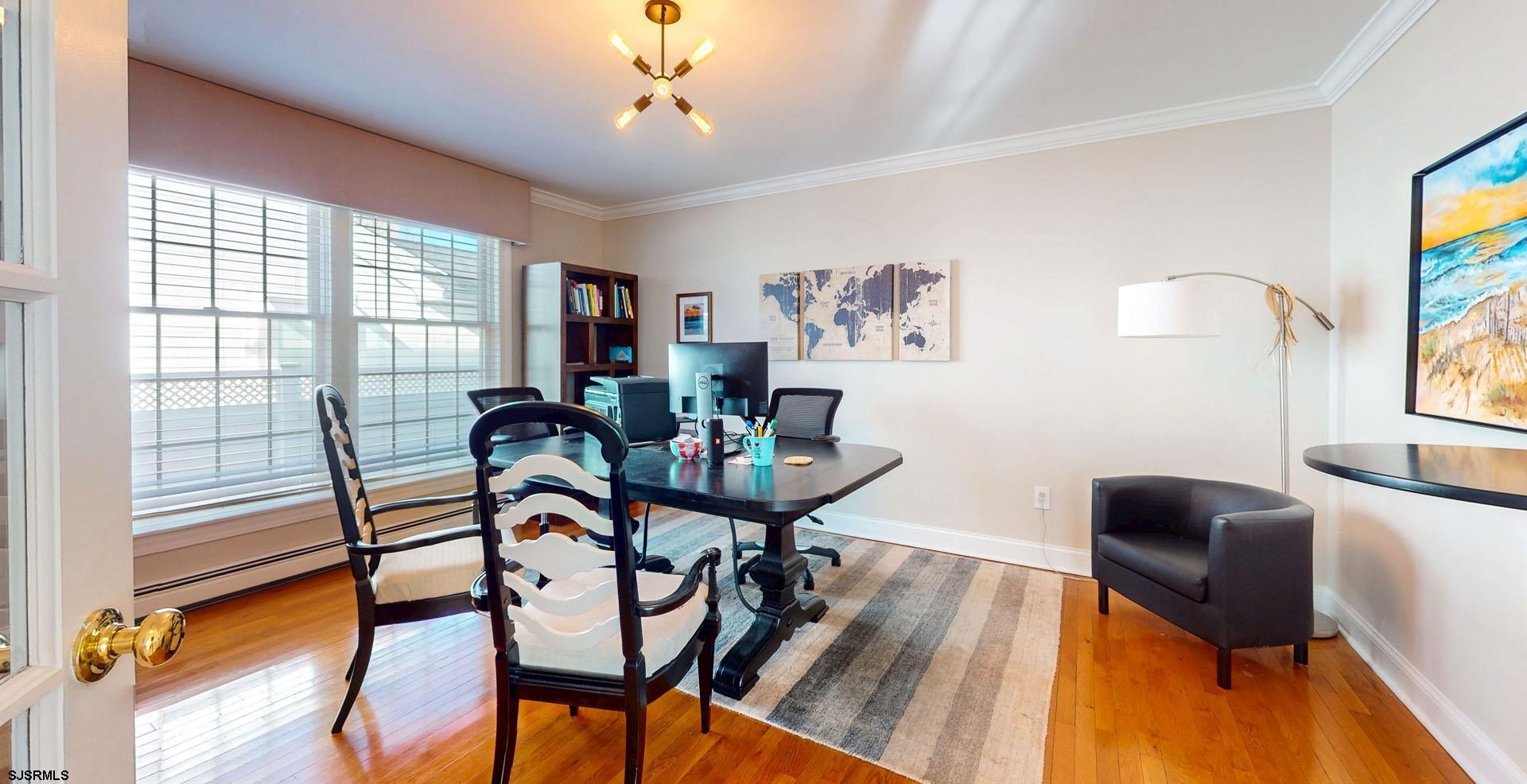 39 Spruce Road Ocean City, NJ 08226 - Photo 8 of 51 a view of a dining room with furniture a chandelier and wooden floor