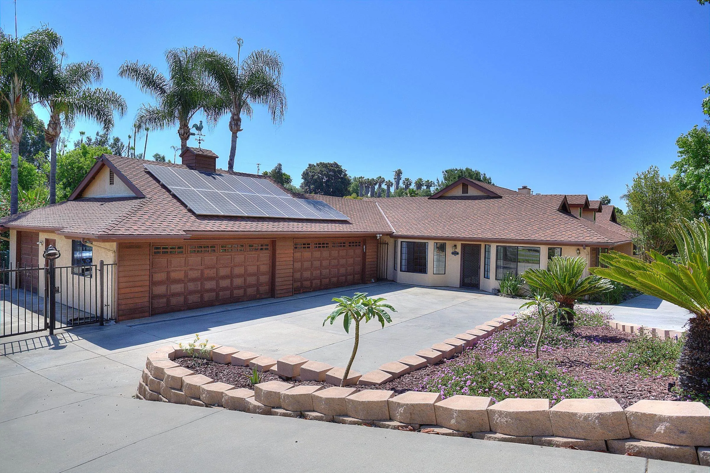 1032 Los Alisos Drive North Fallbrook, CA 92028 - Photo 40 of 44 a front view of a house with a yard and garage