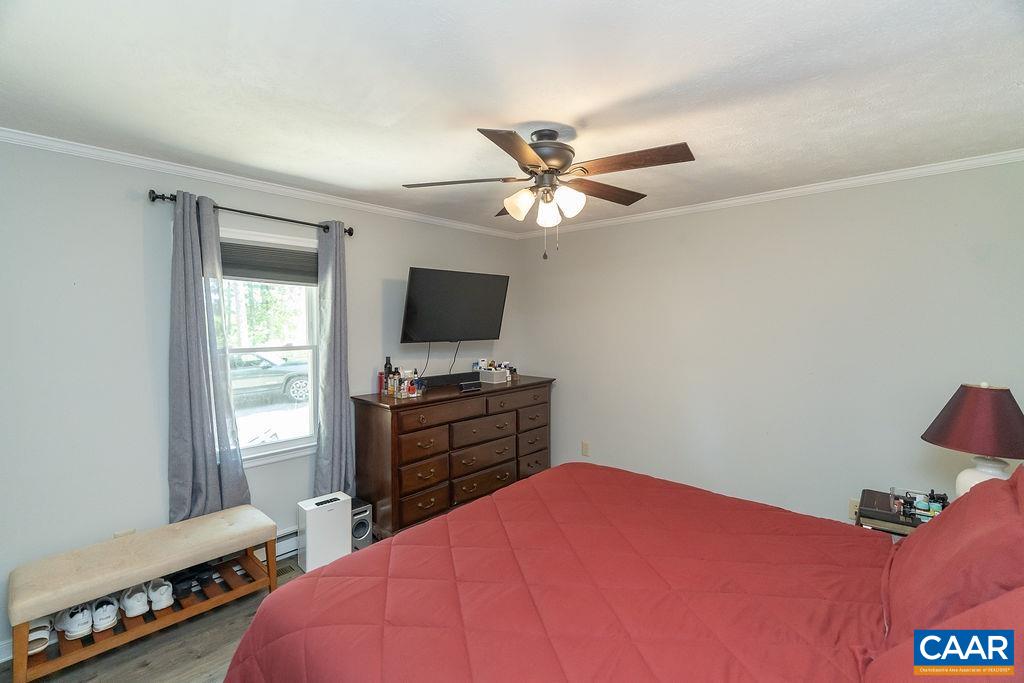 6920 Albevanna Spring Road Scottsville, VA 24590 - Photo 23 of 47 a bedroom with a bed and a flat screen tv