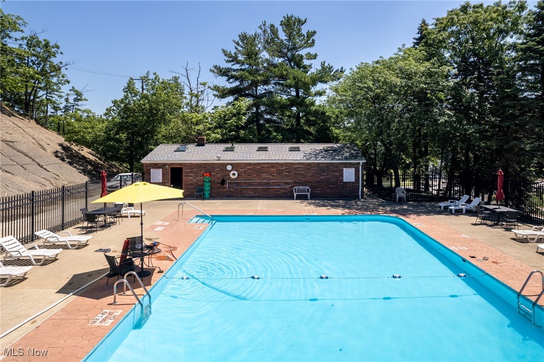 6480 State Road, Unit F7 Parma, OH 44134 - Photo 30 of 33 Community pool with a patio area and view of scattered trees