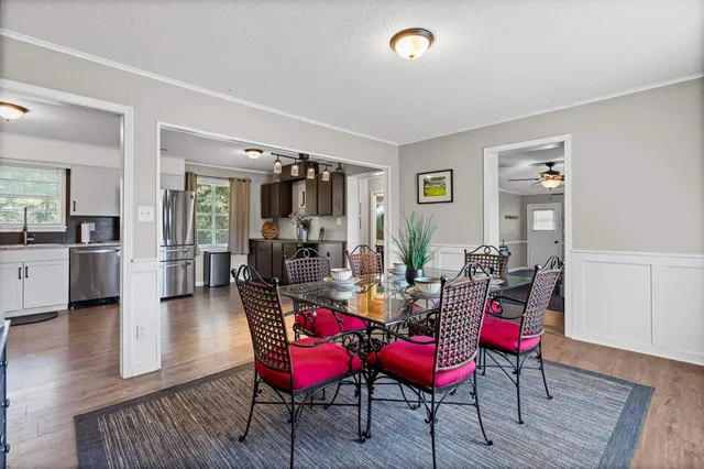 a view of a dining room with furniture and wooden floor