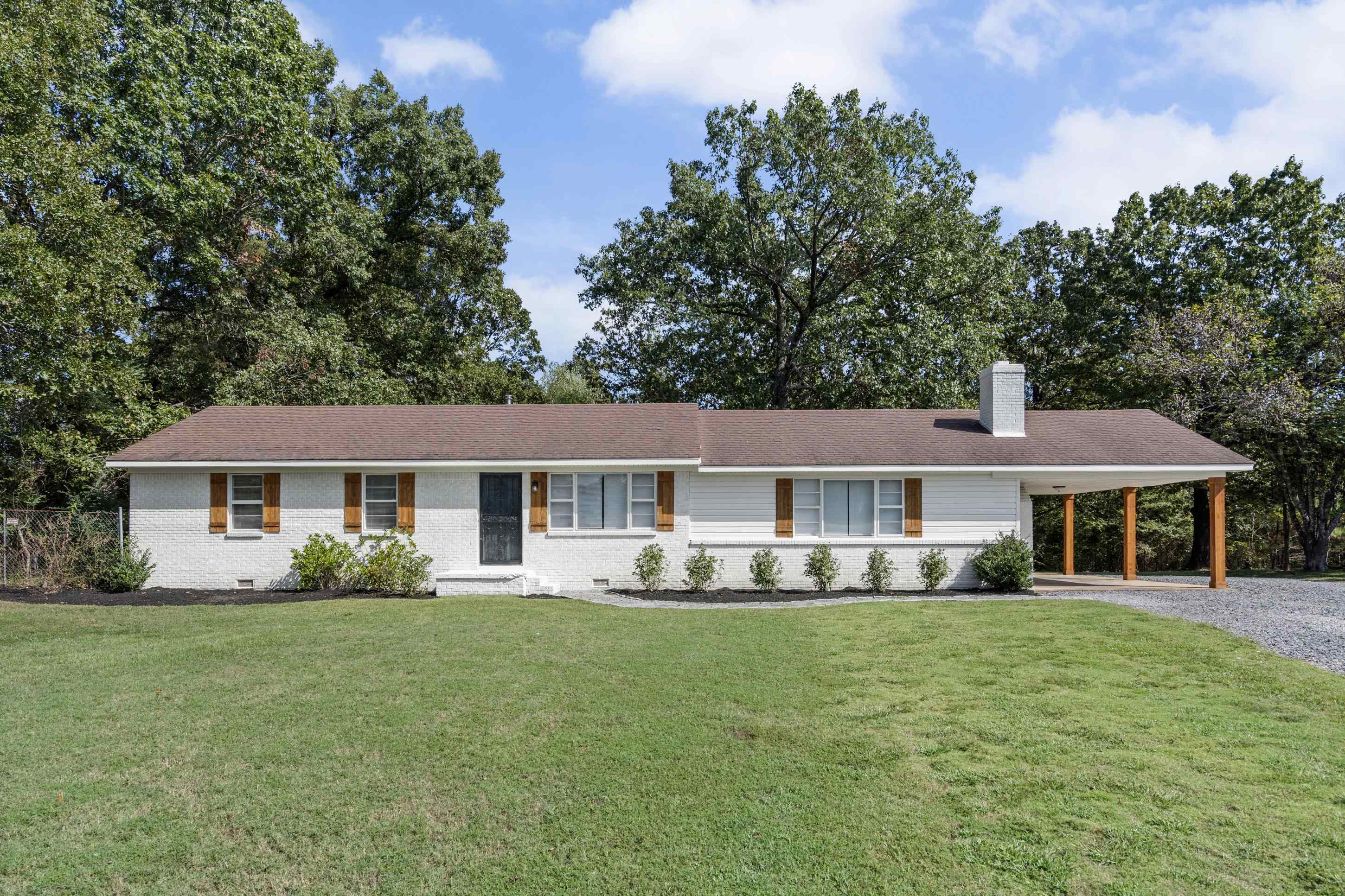 2805 Slayden Road Moscow, TN 38057 - Photo 16 of 28 Ranch-style house featuring a front yard, a chimney, an attached carport, driveway, and brick siding