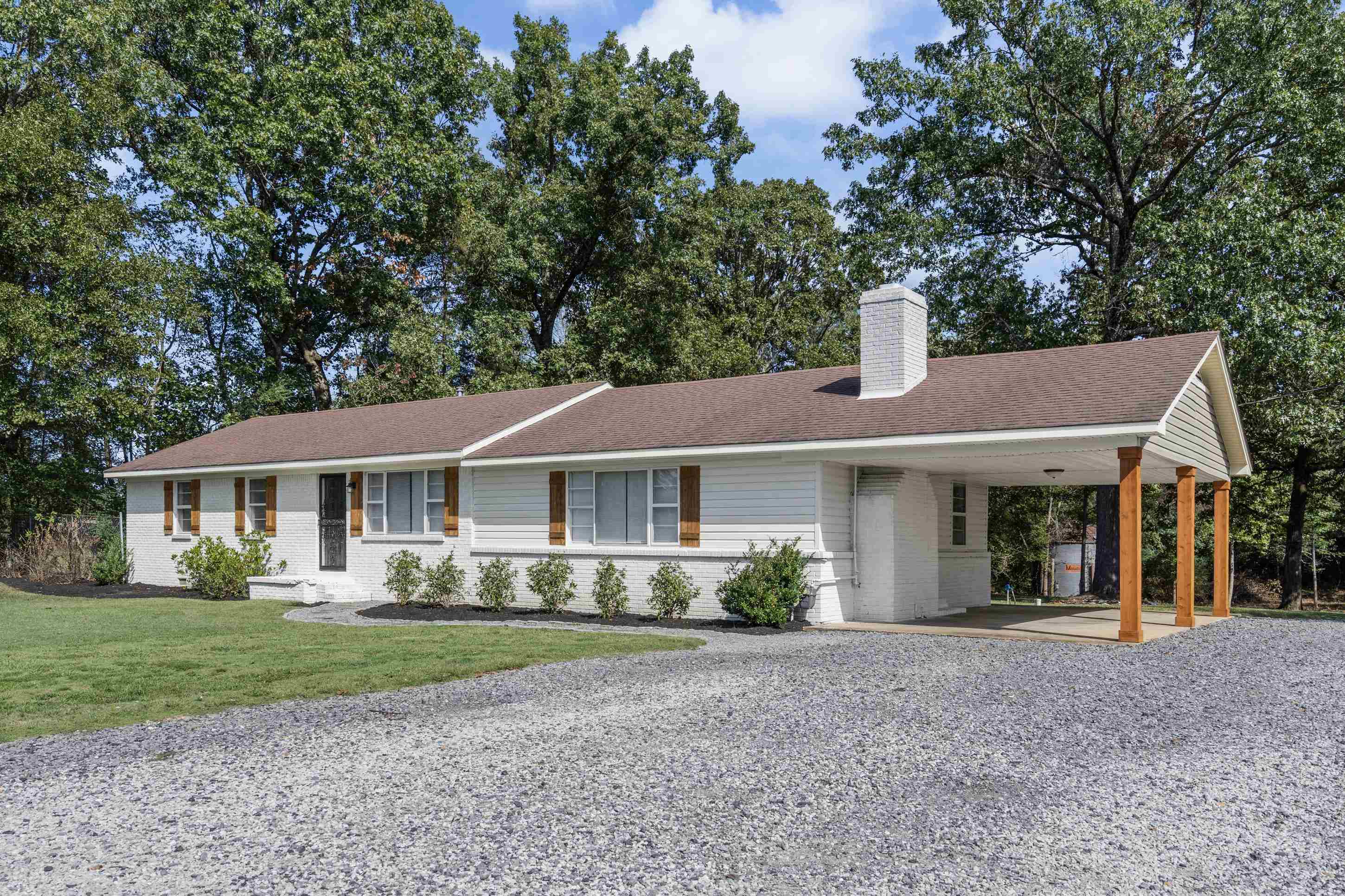 2805 Slayden Road Moscow, TN 38057 - Photo 18 of 28 Ranch-style house featuring brick siding, a chimney, an attached carport, driveway, and a front lawn