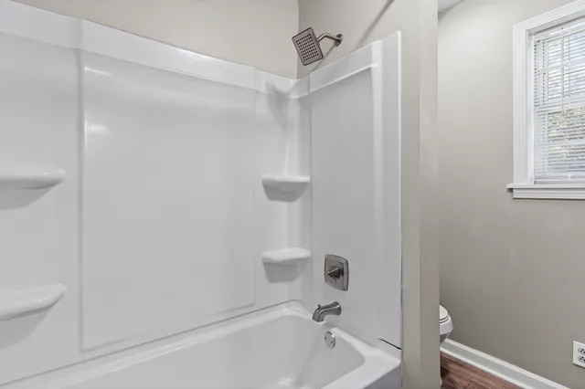 a bathroom with a bathtub and a toilet