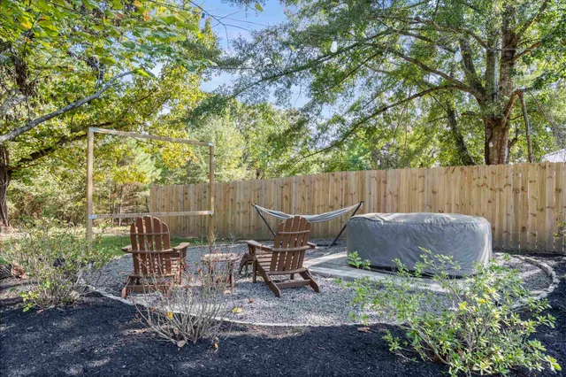 a view of outdoor sitting area with furniture and wooden fence