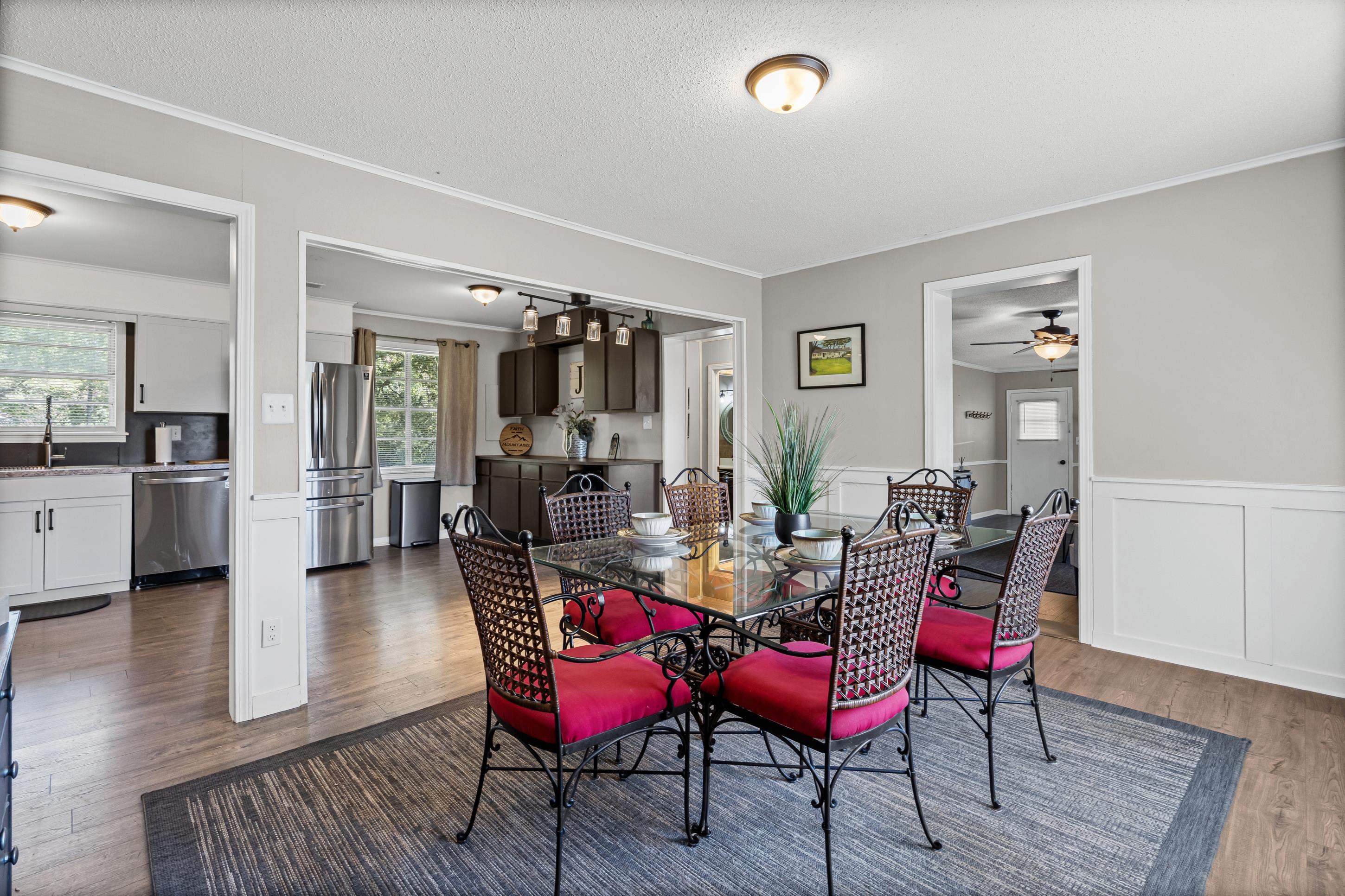 2805 Slayden Road Moscow, TN 38057 - Photo 26 of 28 Dining space featuring dark wood finished floors, ornamental molding, a textured ceiling, wainscoting, and ceiling fan