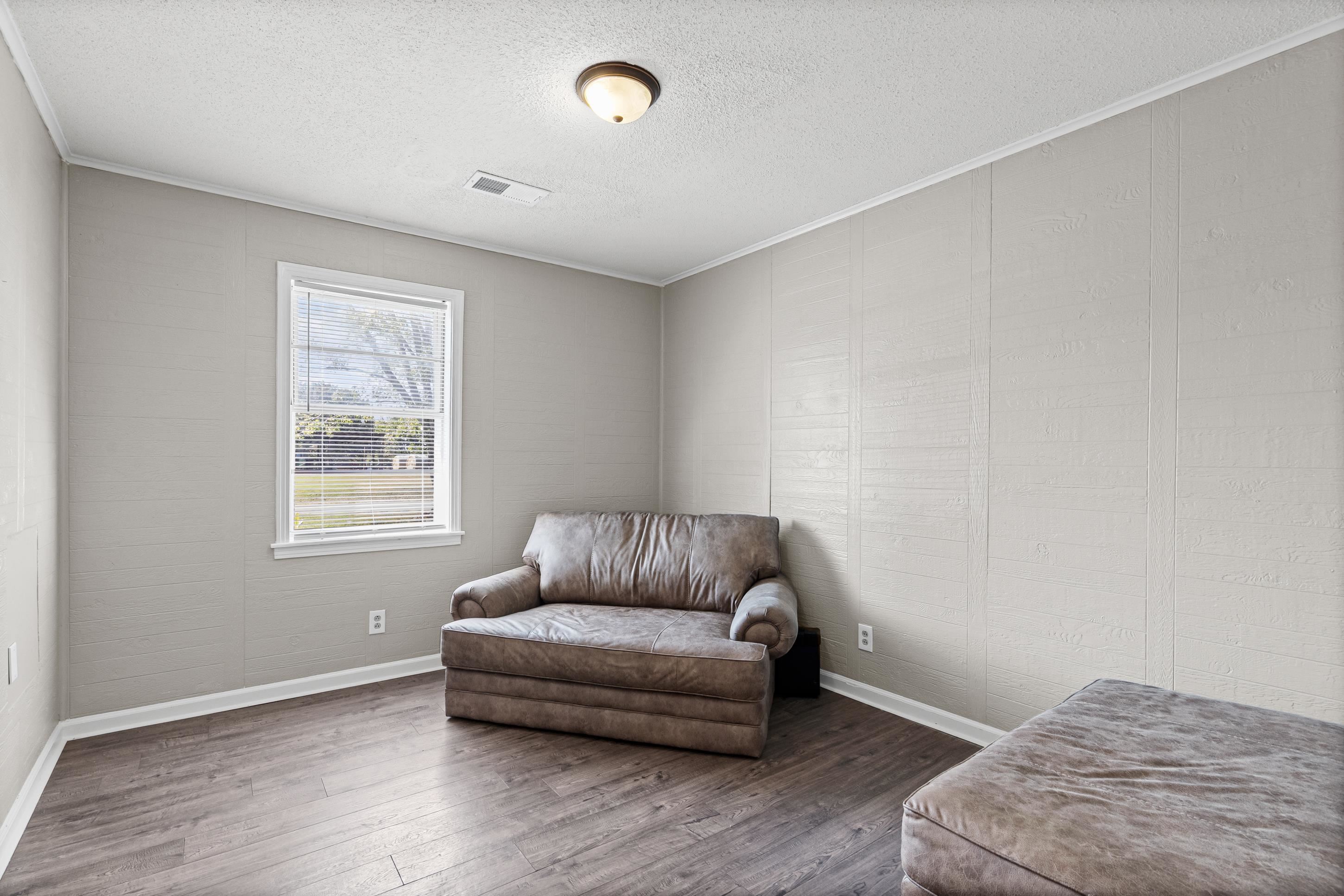 2805 Slayden Road Moscow, TN 38057 - Photo 4 of 28 Sitting room featuring wood finished floors, ornamental molding, and a textured ceiling