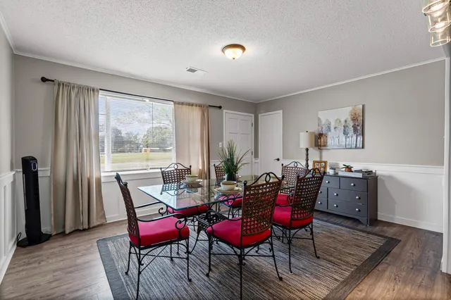 a view of a dining room with furniture and wooden floor