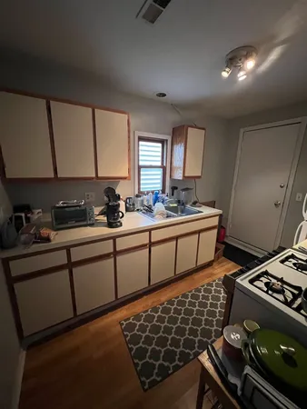 a kitchen with stainless steel appliances a stove a sink and a cabinets