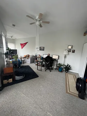 a living room with furniture gym equipment and a chandelier