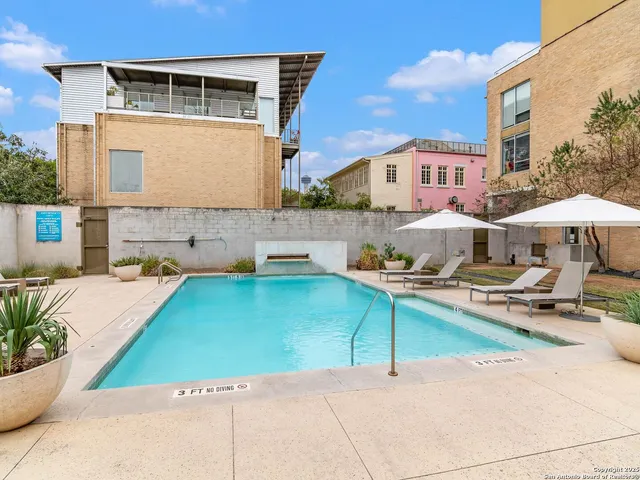 a aerial view of a house with swimming pool and sitting area
