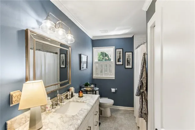 a bathroom with a sink toilet and mirror