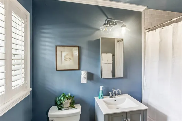 a bathroom with a sink mirror and window