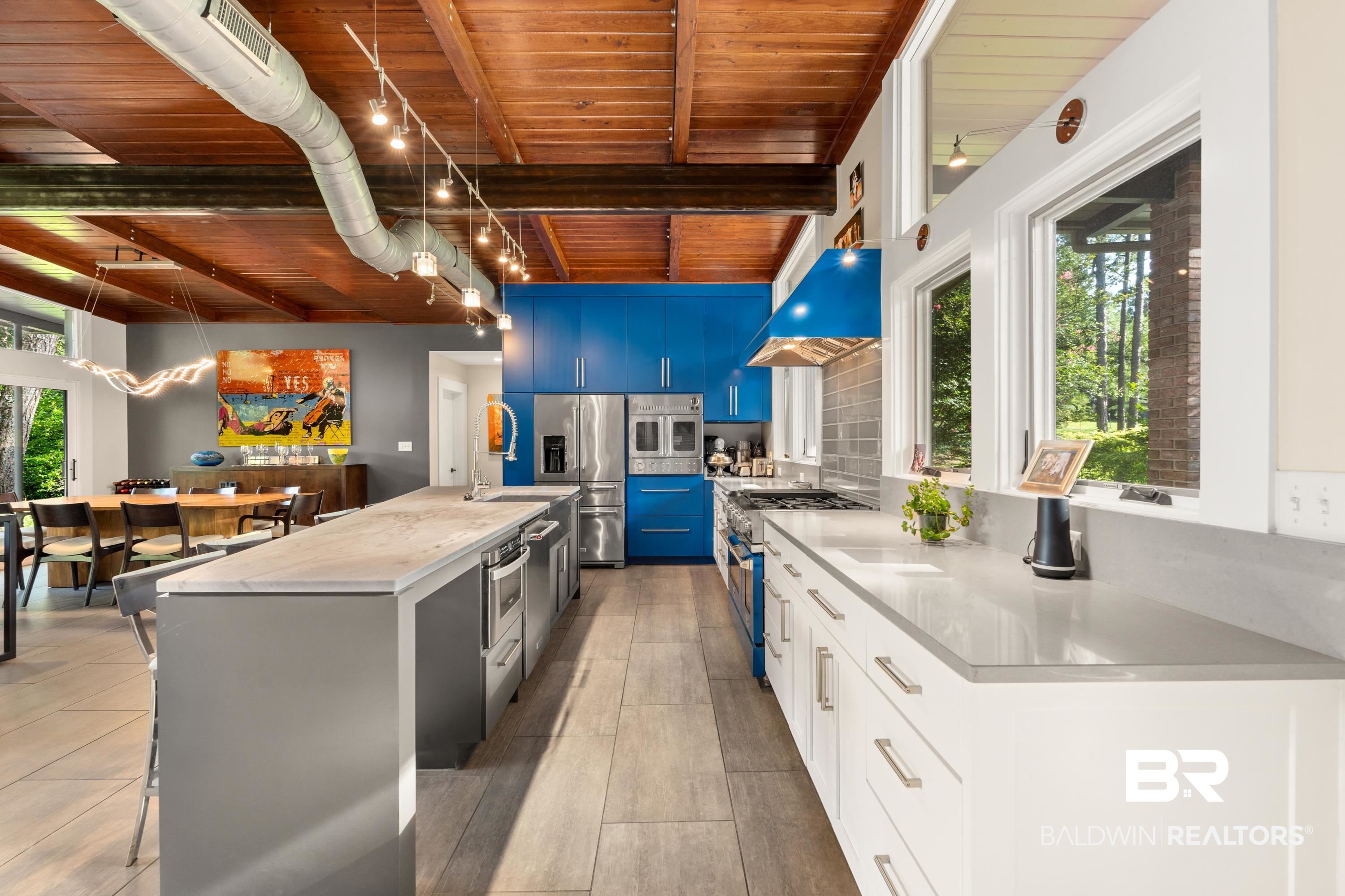 233 Suzanne Circle Mobile, AL 36608 - Photo 16 of 85 Kitchen featuring healthy amount of natural light, pendant lighting, a kitchen island with sink, appliances with stainless steel finishes, and a wooden ceiling with exposed beams