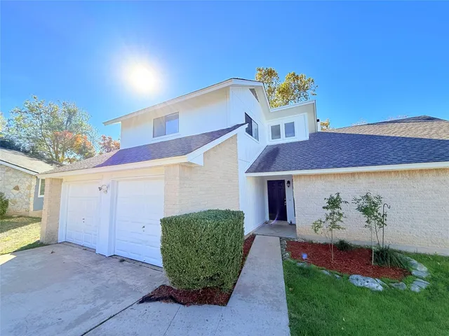 a view of a house with a potted plant and a window
