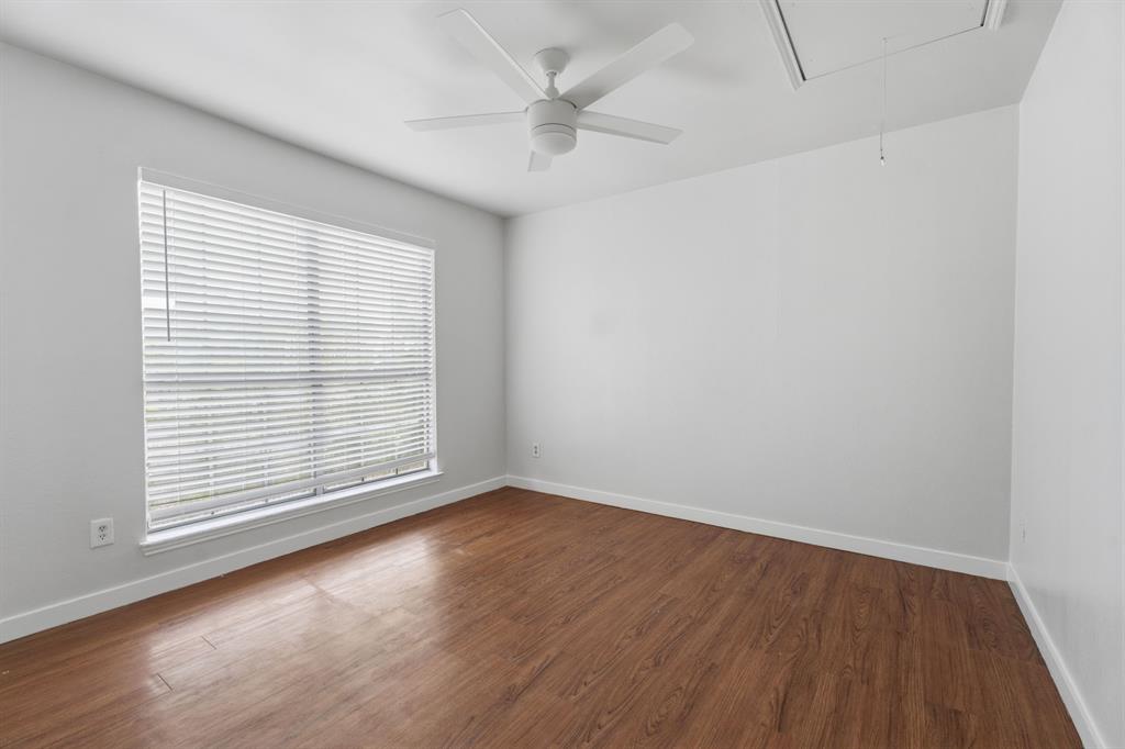 3721 Smartt Street Rowlett, TX 75088 - Photo 21 of 27 an empty room with wooden floor and windows