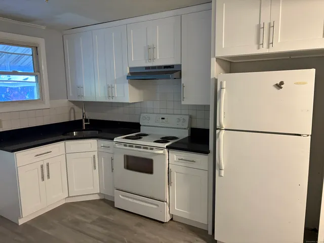 a kitchen with a white cabinets and white appliances