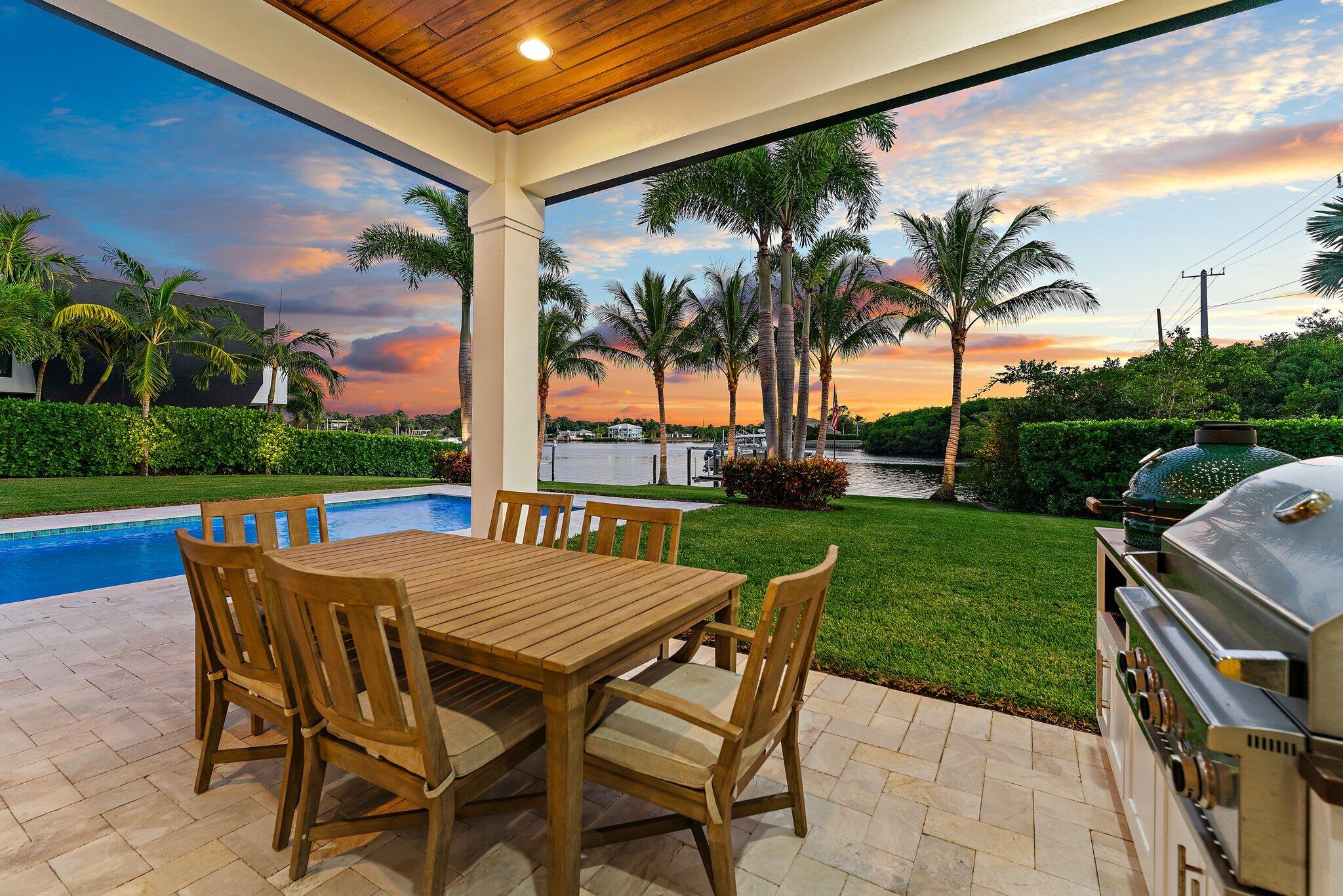 5730 Holly Lane Jupiter, FL 33458 - Photo 29 of 58 a view of a patio with a table and chairs