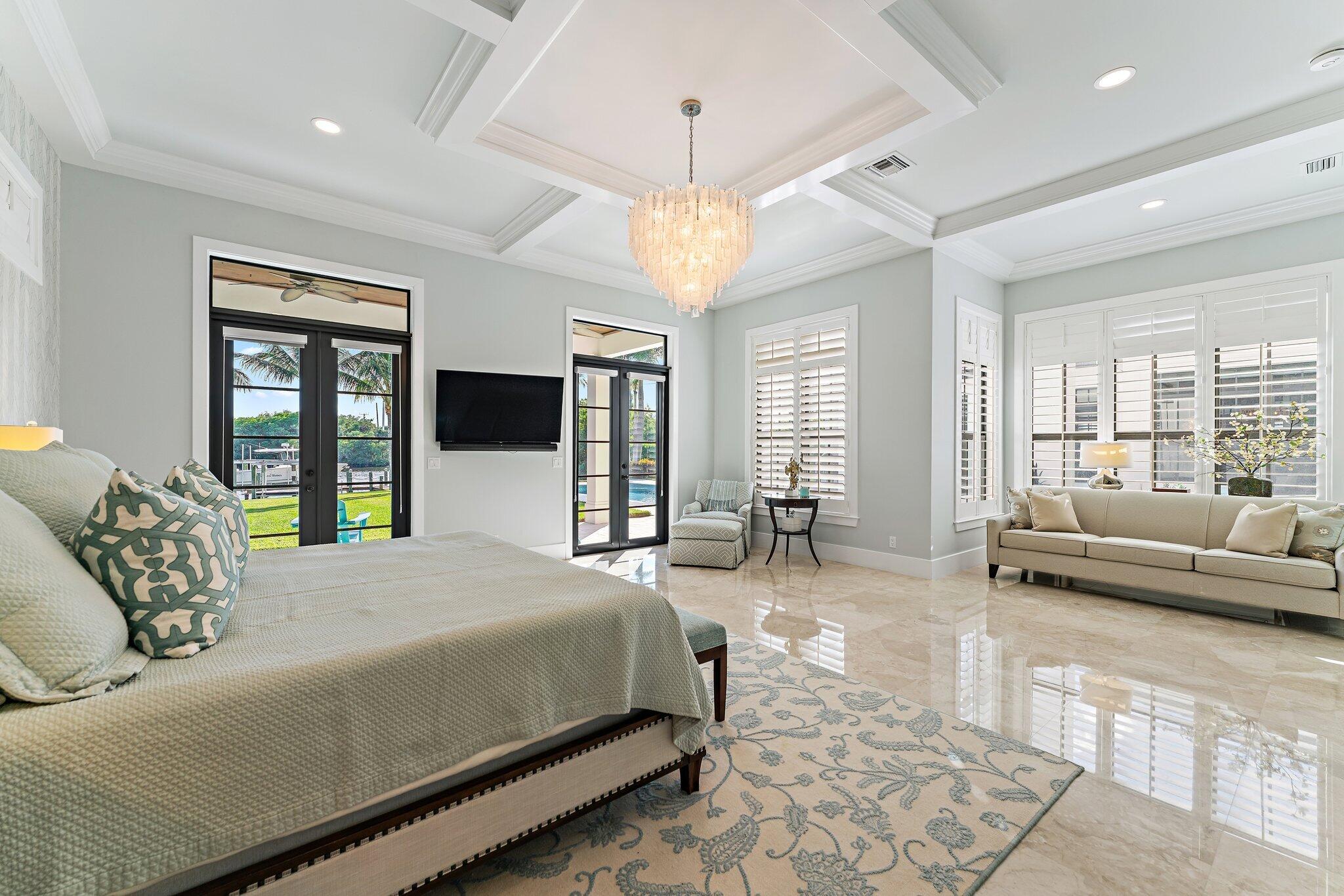5730 Holly Lane Jupiter, FL 33458 - Photo 34 of 58 a spacious bedroom with a large bed and a couch
