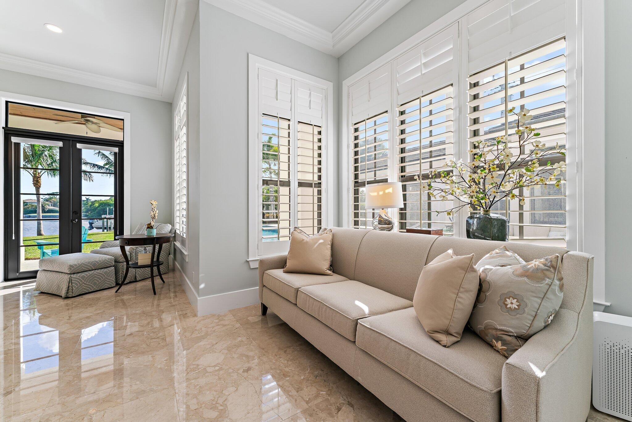 5730 Holly Lane Jupiter, FL 33458 - Photo 36 of 58 a living room with furniture and floor to ceiling windows
