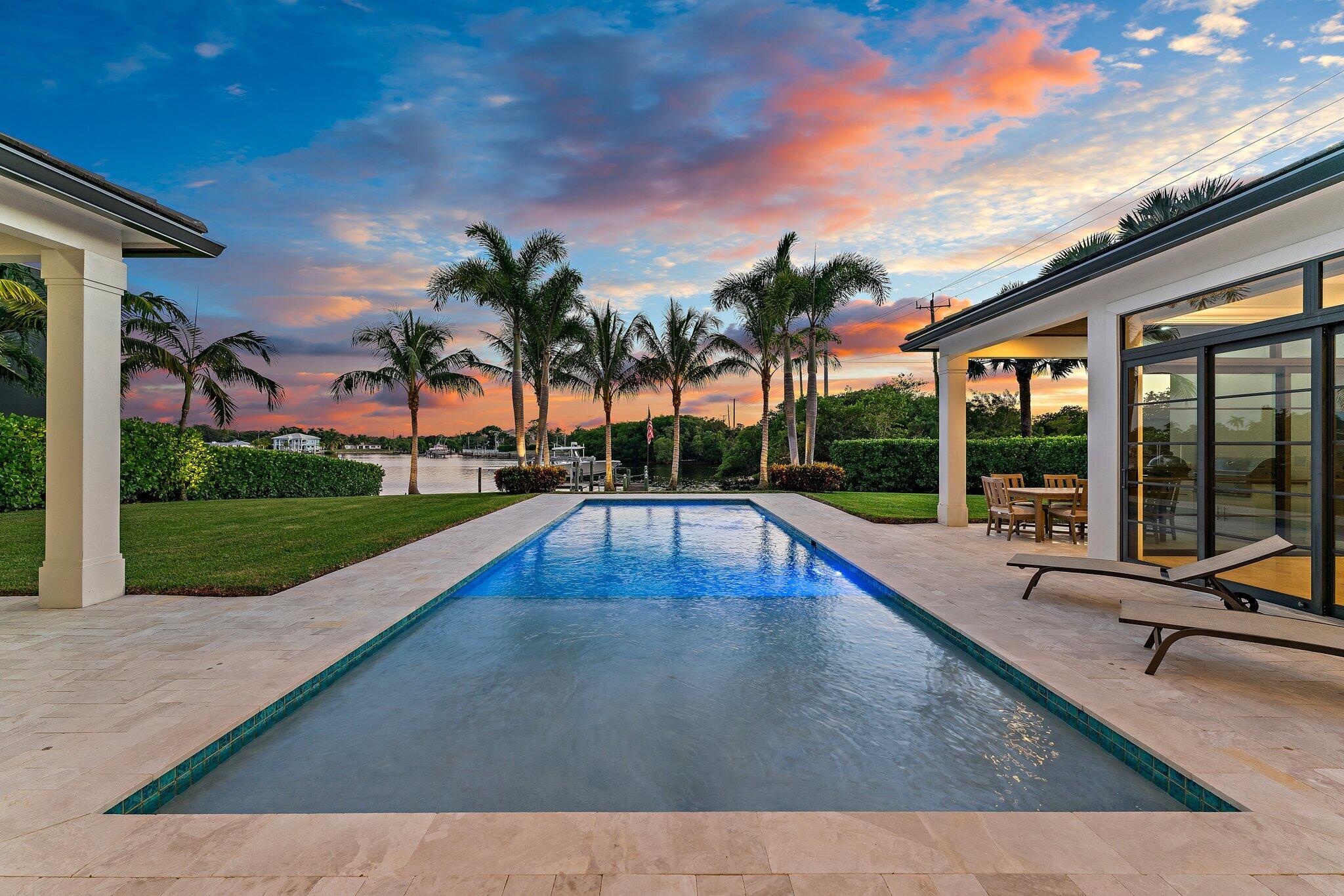 5730 Holly Lane Jupiter, FL 33458 - Photo 40 of 58 a view of swimming pool with a patio and a yard