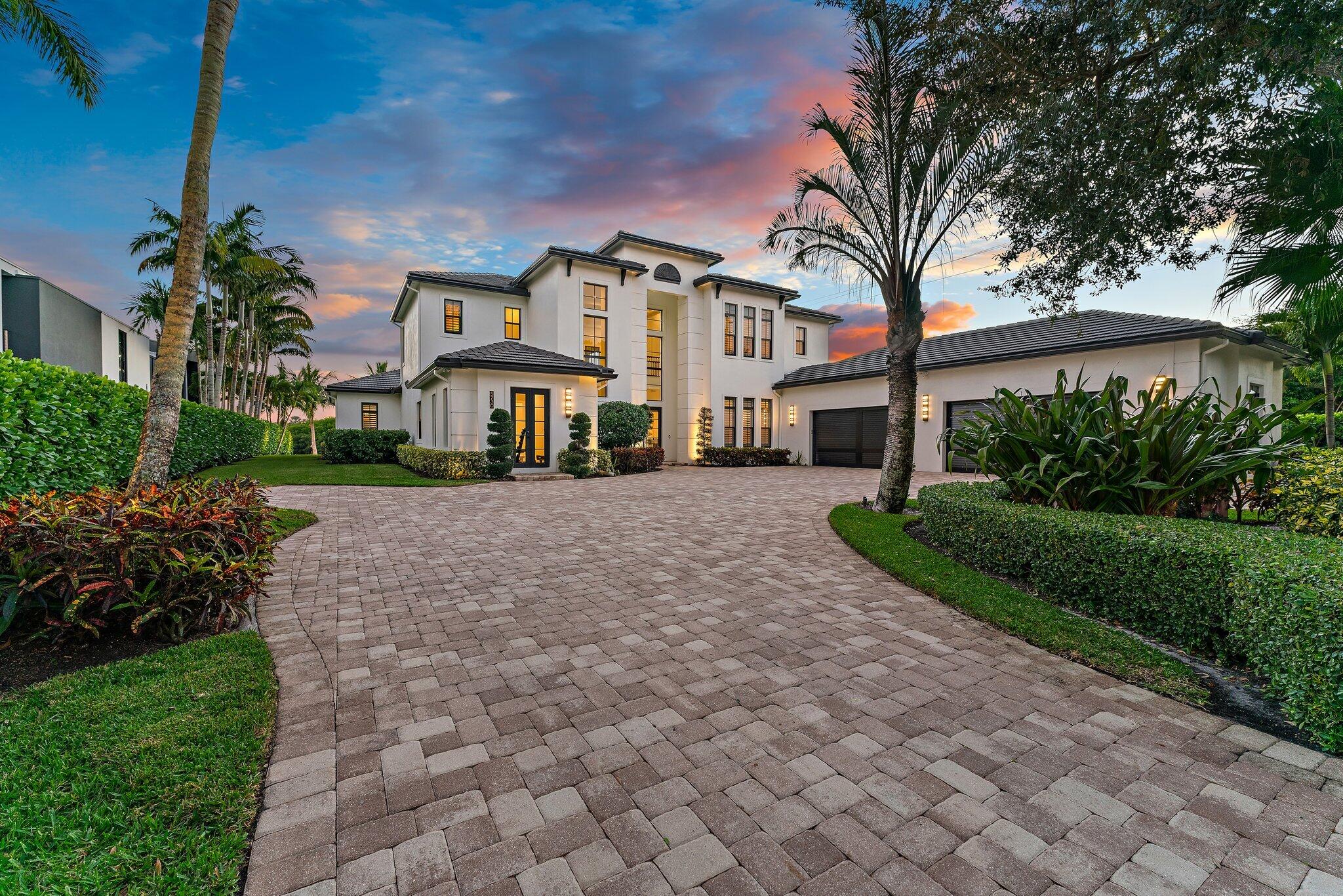 5730 Holly Lane Jupiter, FL 33458 - Photo 4 of 58 a front view of a house with a garden and trees