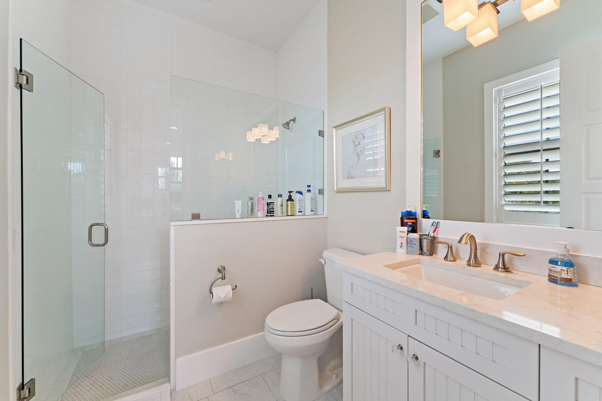 5730 Holly Lane Jupiter, FL 33458 - Photo 44 of 58 a bathroom with a sink a toilet and shower