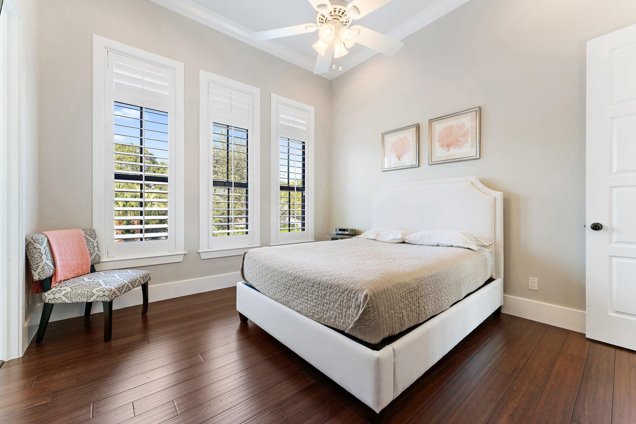 5730 Holly Lane Jupiter, FL 33458 - Photo 45 of 58 a bedroom with a bed and a chair
