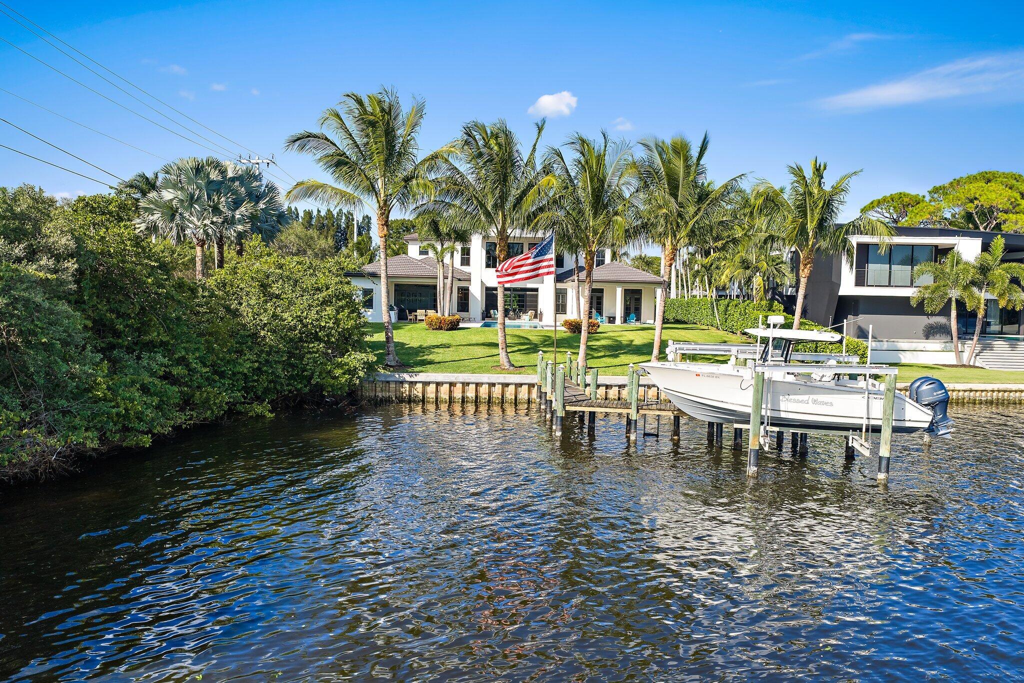 5730 Holly Lane Jupiter, FL 33458 - Photo 54 of 58 a view of a swimming pool with a table and chairs