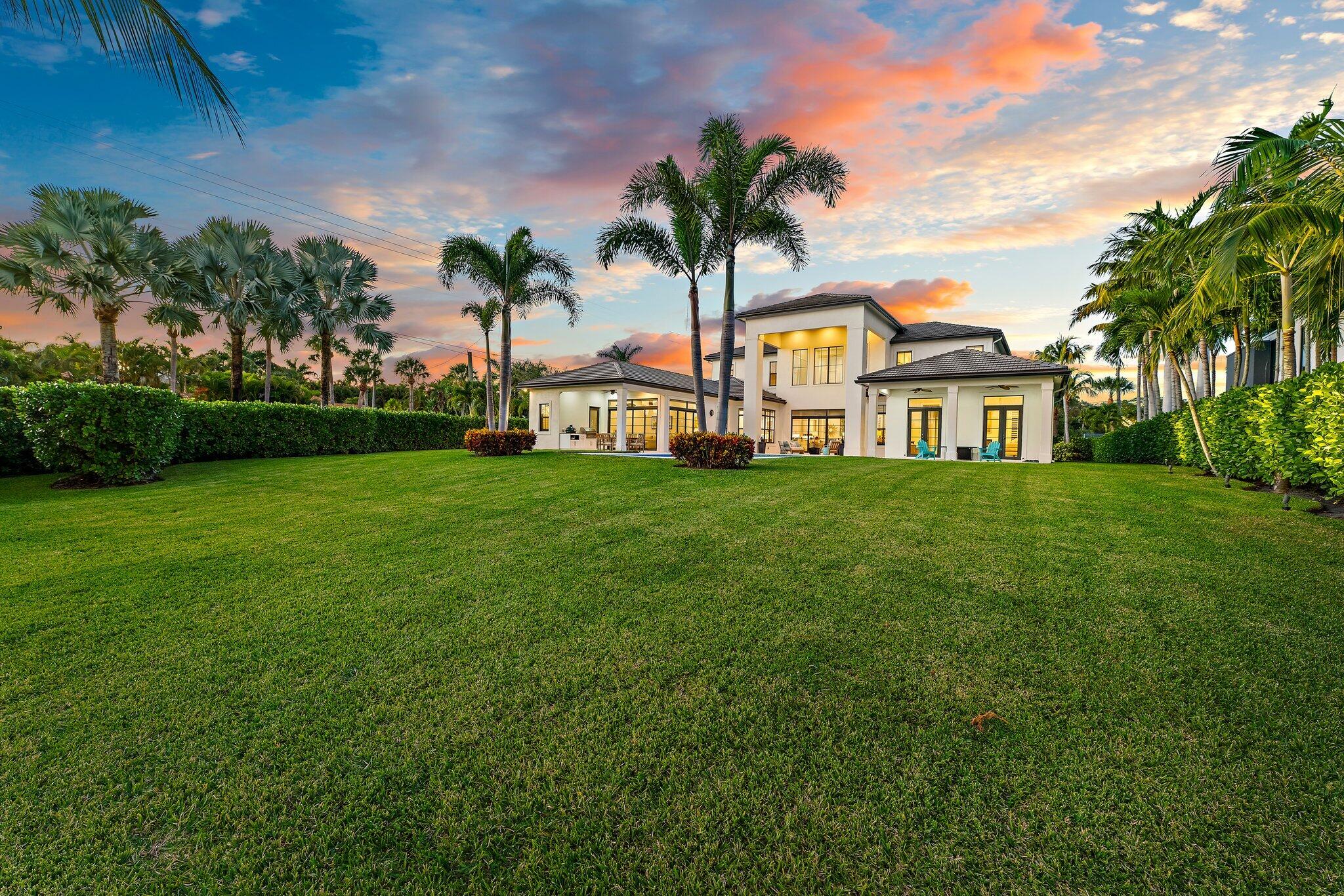 5730 Holly Lane Jupiter, FL 33458 - Photo 7 of 58 a view of a house with a big yard and palm trees