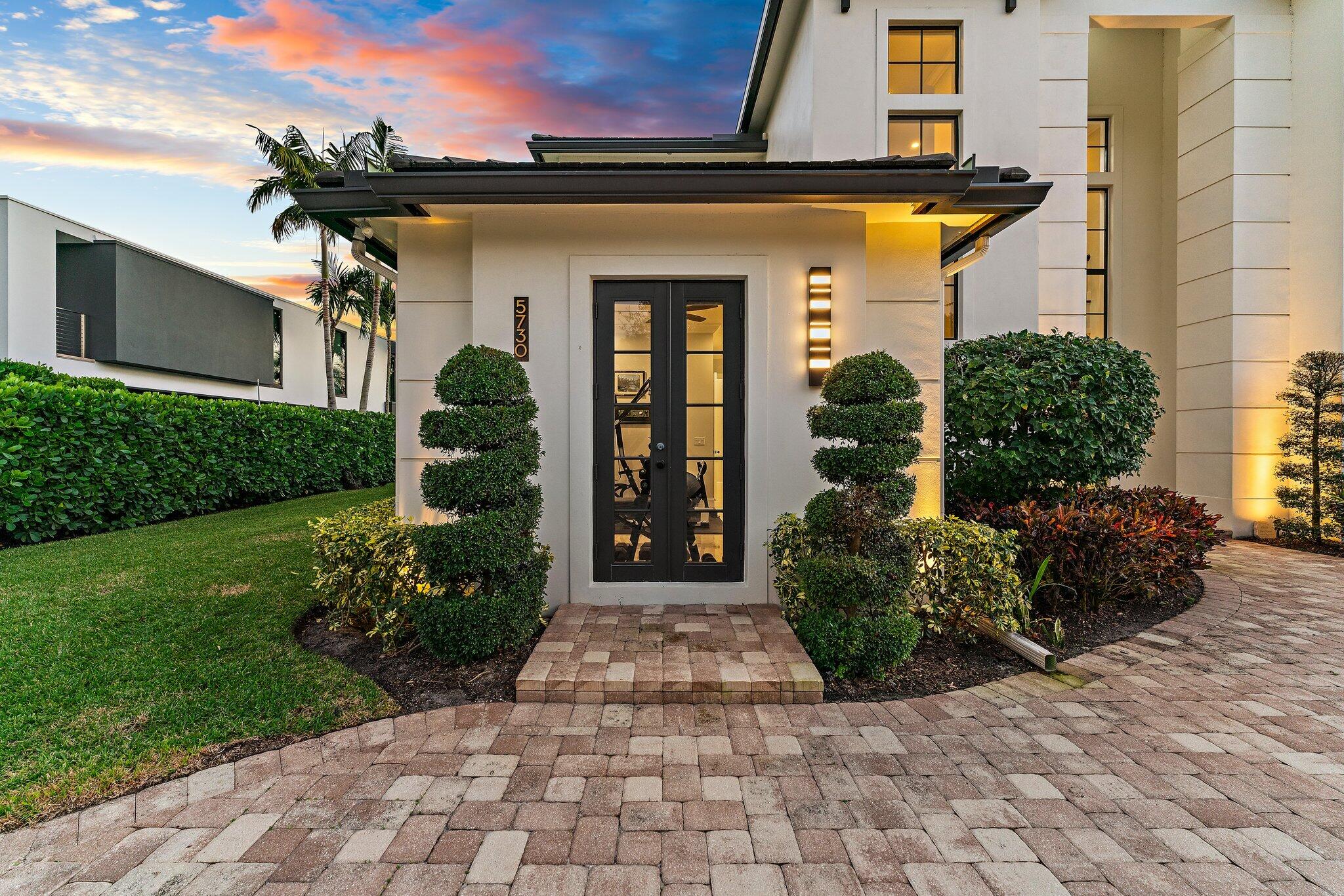 5730 Holly Lane Jupiter, FL 33458 - Photo 9 of 58 a front view of a house with garden