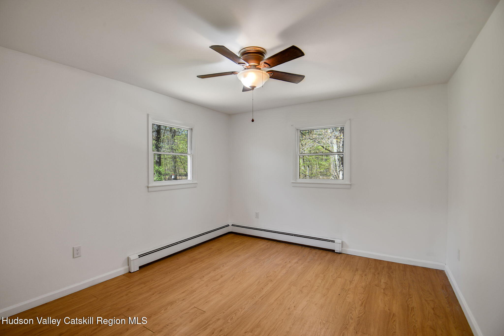 81 Mountain Turnpike Road Catskill, NY 12414 - Photo 12 of 36 an empty room with a window and a ceiling fan