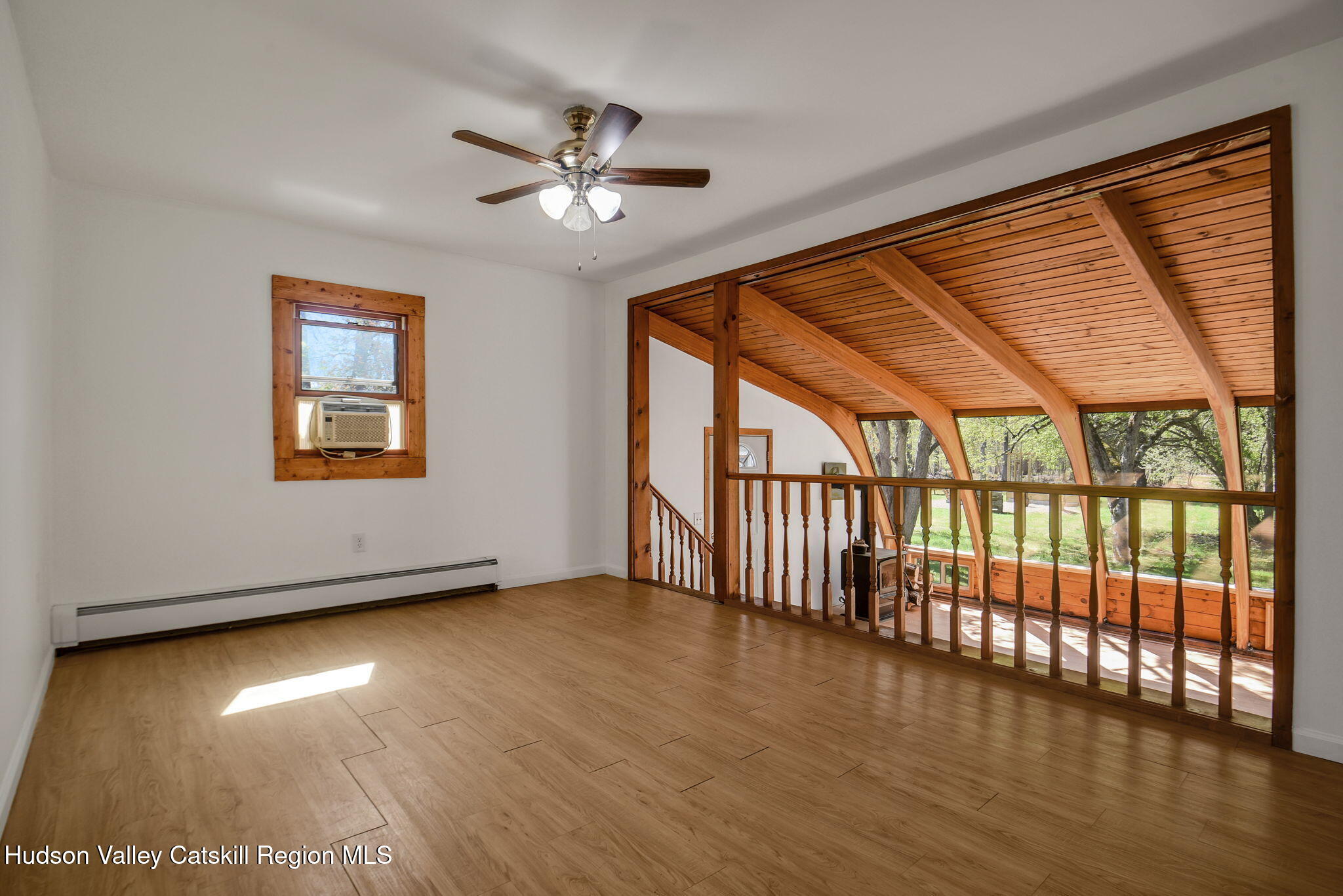 81 Mountain Turnpike Road Catskill, NY 12414 - Photo 7 of 36 a view of an empty room with wooden floor and a window