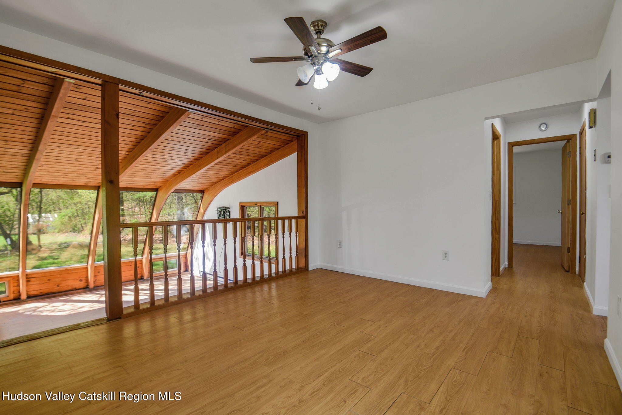 81 Mountain Turnpike Road Catskill, NY 12414 - Photo 8 of 36 an empty room with wooden floor and windows