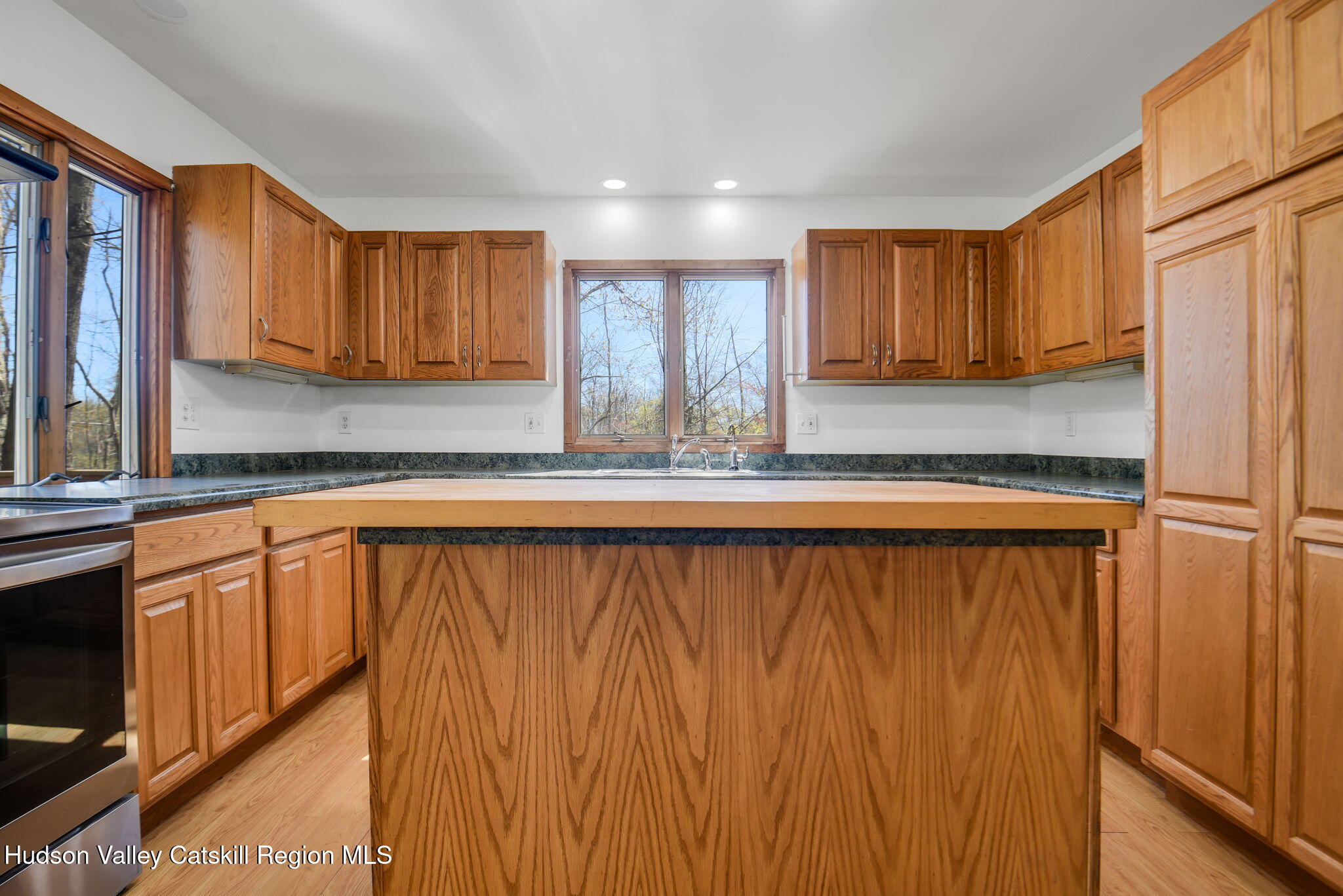81 Mountain Turnpike Road Catskill, NY 12414 - Photo 10 of 36 a kitchen with stainless steel appliances granite countertop wooden cabinets a sink and a window