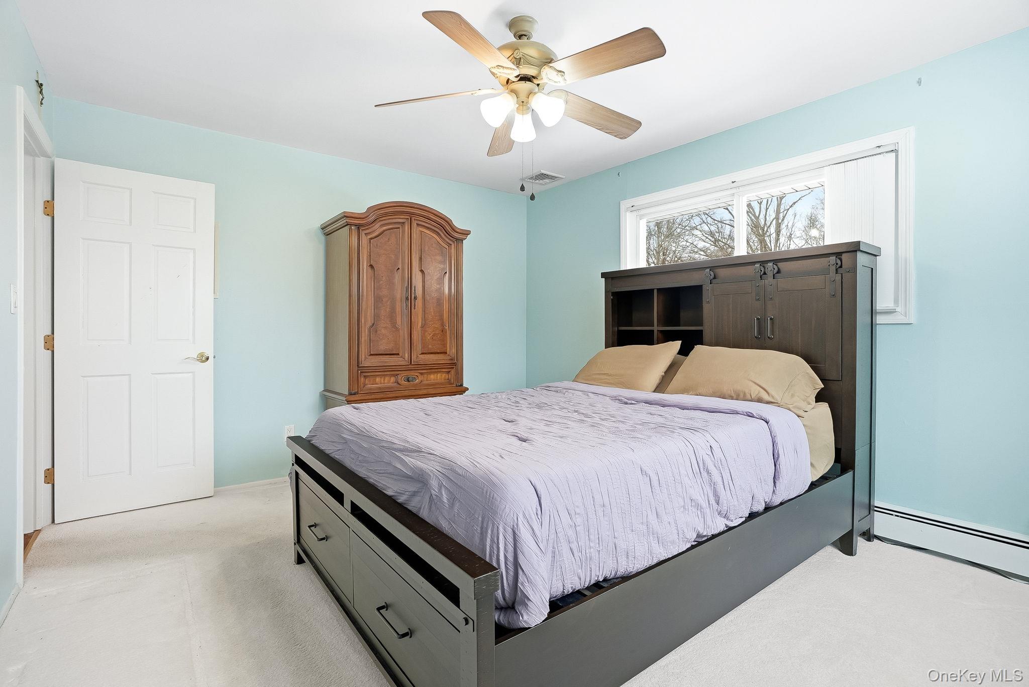 12 Lakeview Road Carmel, NY 10512 - Photo 13 of 31 a bedroom with a bed and a chandelier